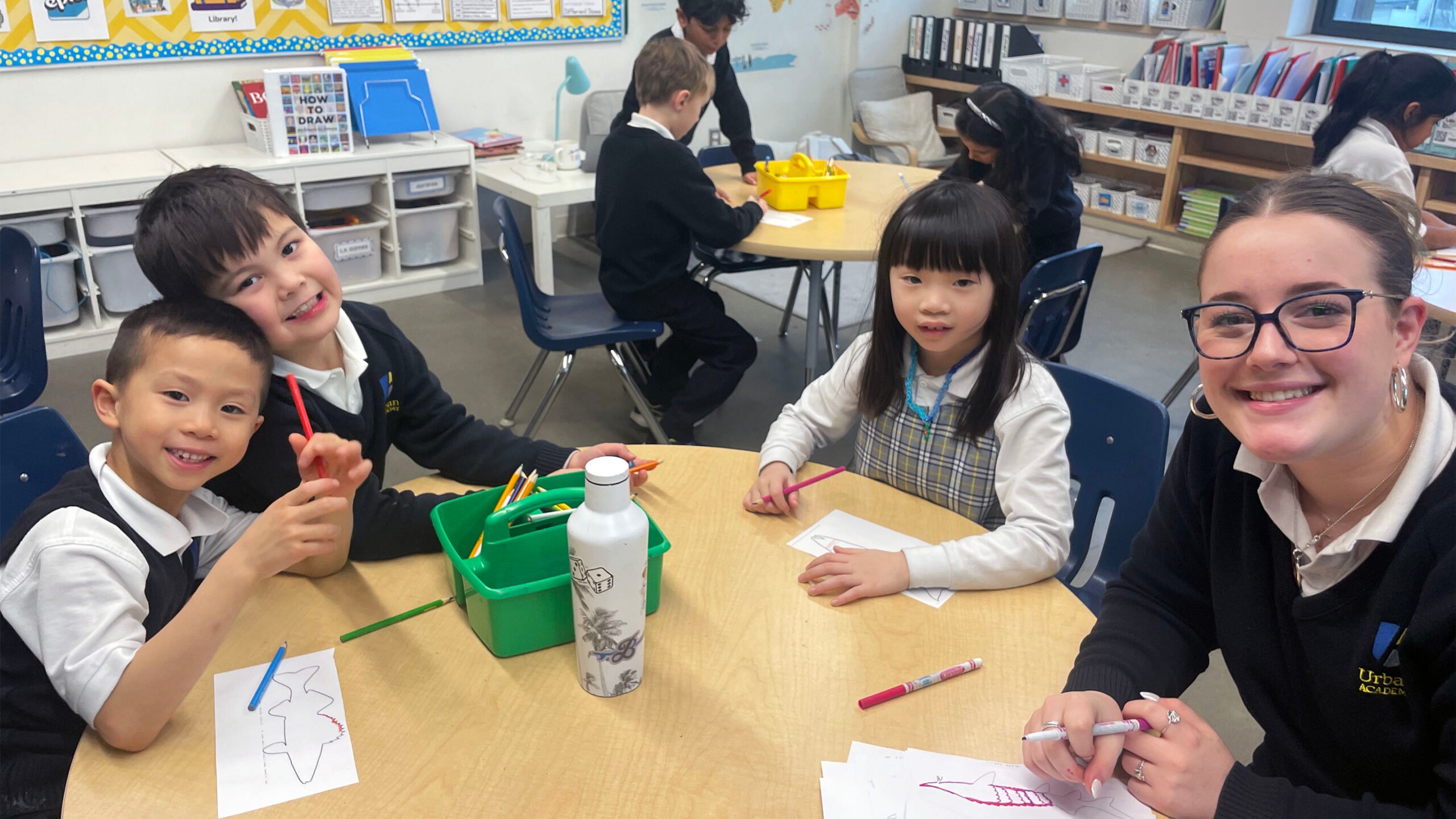 Sr. School students collaborating with Jr. School students on an art mural.