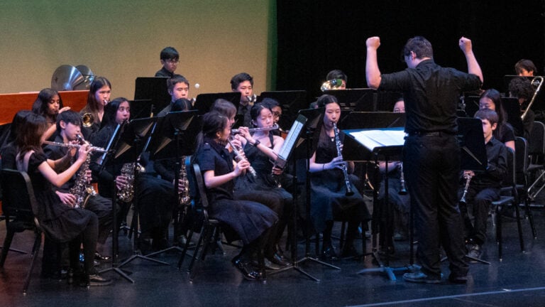 Urban Academy student conducting band at annual Spring Concert.